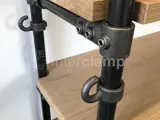 black powder coated steel tube creating wooden shelving with hooks on the end