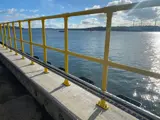 Interclamp double rail key clamp system, powder coated yellow, installed on a jetty