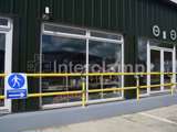 yellow powder coated DDA disability handrails outside of cafe in Haverfordwest