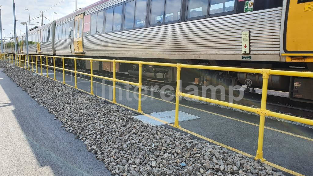 A GRP guardrail constructed from Interclamp GRP fittings and tube, providing a barrier from a busy rail track