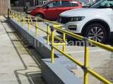 yellow powder coated DDA disability handrails outside of cafe in Wales. 