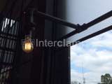 Black powder coated steel tube with light fitted in a cafe 