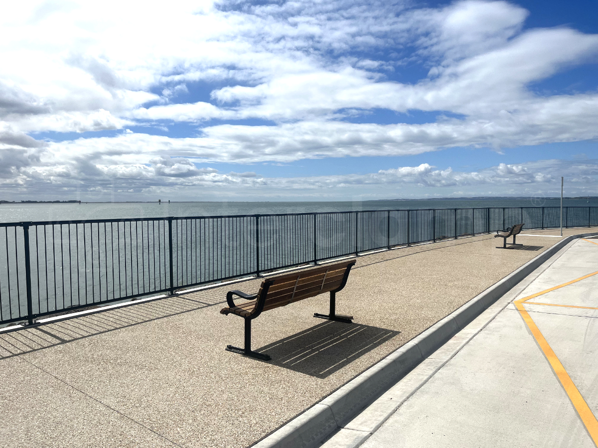 Black powder coated Interclamp Pedestrian Barriers installed along the sea front at Geelong Port
