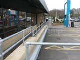 Pedestrian safety handrails fitted at a service station in England using Interclamp steel tube and fittings 