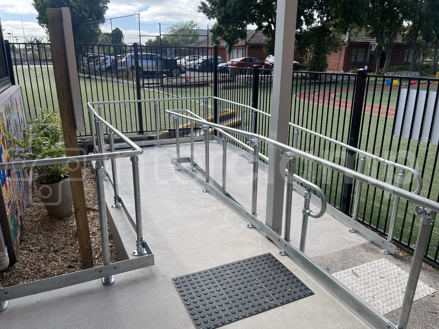 Interclamp DDA Assist key clamp handrail installed on an access ramp for a primary school