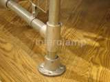 Clothing rail base up close on wooden floor. Using Interclamp steel clamp fittings 