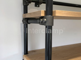black and grey powder coated steel tube on wooden shelves creating storage