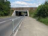 Pedestrian handrail barrier fitted on the side of a busy road just before a tunnel