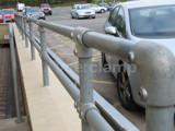 up close picture of tube clamp connected to handrails fitted at service station in England